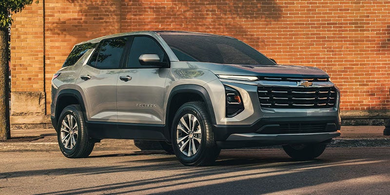 A green 2025 Chevy Equinox from the rear at an angle.