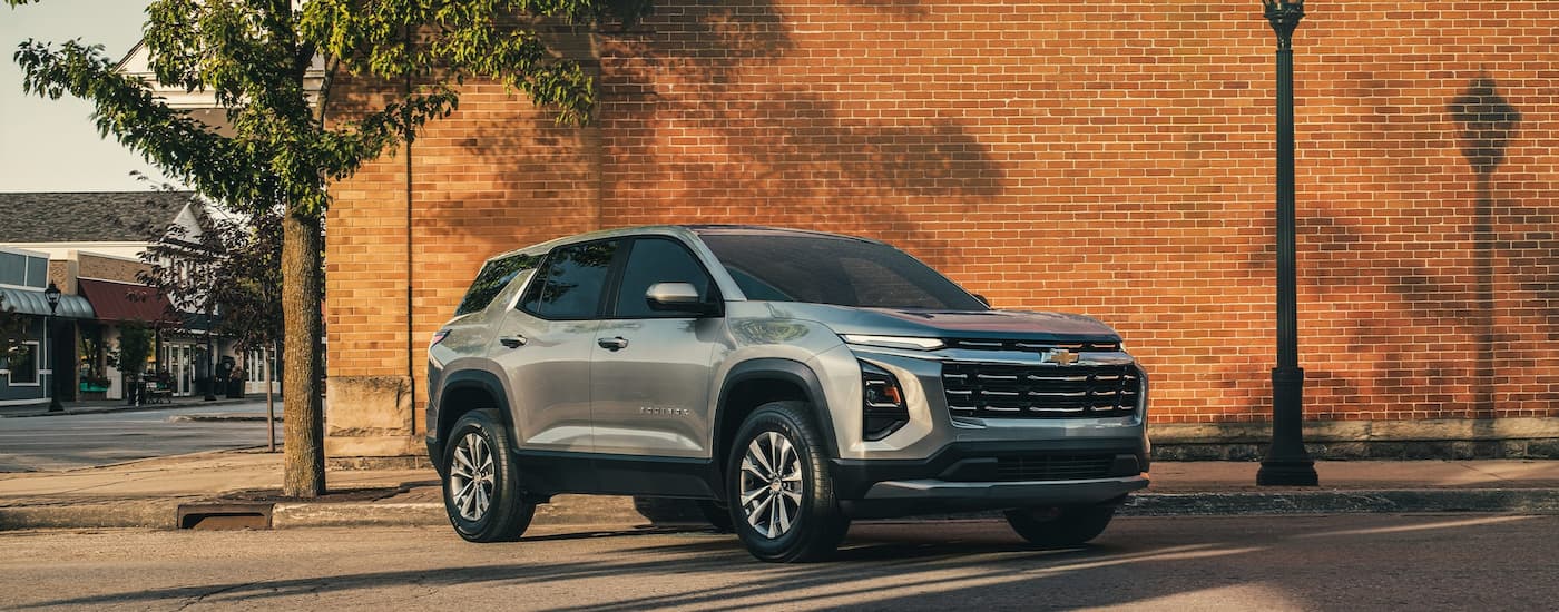 Silver 2026 Chevy Equinox parked in front of a brick wall.